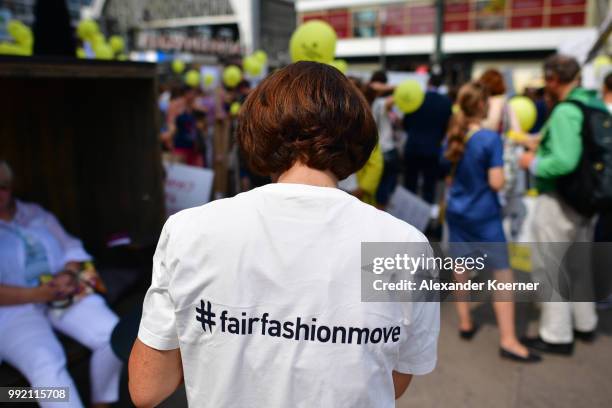Workers of the fashion industry and protesters participate in the Greenshowroom Fair Fashion Move from Alexanderplatz to Kraftwerk Berlin on July 5,...
