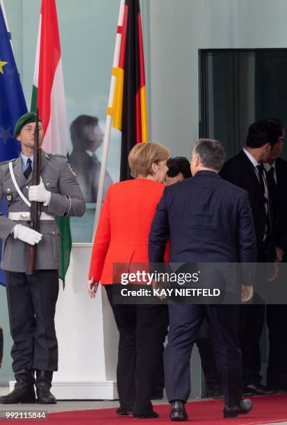 German Chancellor Angela Merkel welcomes Hungarian Prime Minister Viktor Orban before a meeting on July 5, 2018 in Berlin. - Angela Merkel and Viktor...