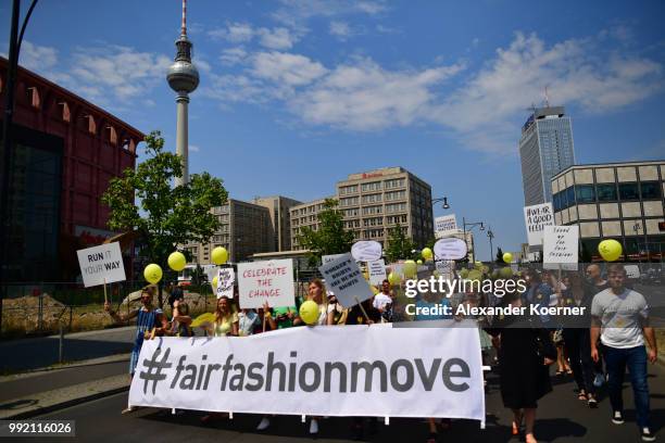 Workers of the fashion industry and protesters participate in the Greenshowroom Fair Fashion Move from Alexanderplatz to Kraftwerk Berlin on July 5,...