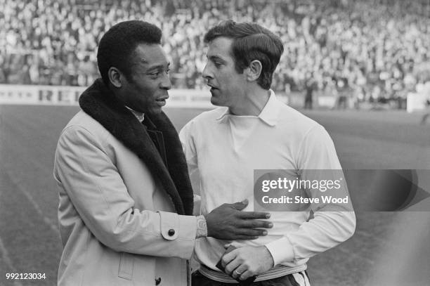 Brazilian soccer player Pele with English soccer player Alan Mullery of Fulham FC, London, UK, 12th March 1973.