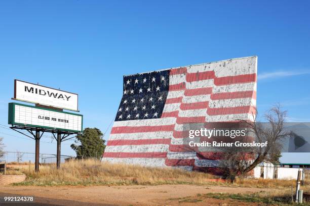 closed drive-in movie theatre with huge painted american flag - rainer grosskopf stock pictures, royalty-free photos & images