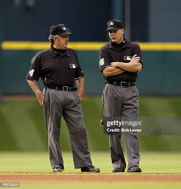 Third base umpire Tim Tschida and second base umpire Tim Timmons chat between innings during a baseball game between the San Diego Padres and Houston...