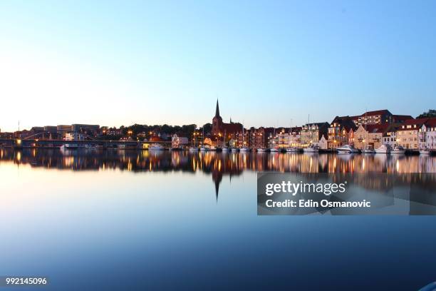 buildings reflected in the harbour of sonderborg, denmark. - jutland stockfoto's en -beelden