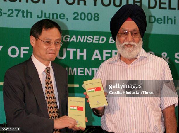 Gill, Union Minister of State for Youth Affairs & Sports and Mr. Zhang Yan, Ambassador of Peoples Republic of China, release a book during the...