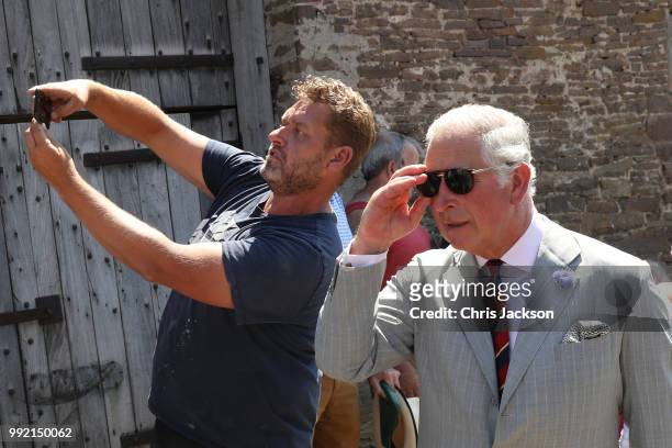 Member of the public takes a "Selfie" with Prince Charles, Prince of Wales as he visits Tretower Court on July 5, 2018 in Crickhowell, Wales.