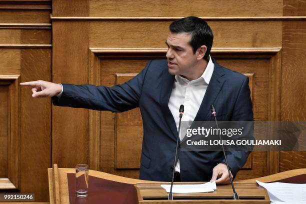 Greece's Prime Minister Alexis Tsipras gestures as he addresses lawmakers in parliament in Athens on July 5 during a debate on the economy and the...