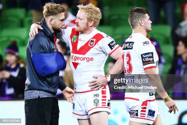 James Graham of the Dragons consoles an injured Jacob Host of the Dragons after their defeat during the round 17 NRL match between the Melbourne...
