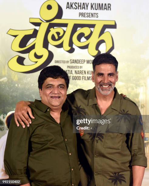 Indian Bollywood actor Swanand Kirkire and actor and producer Akshay Kumar attend the trailer launch of Marathi-language film "Chumbak" in Mumbai on...