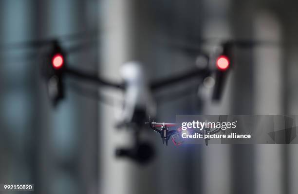 Graupner Alpha 110 drone flying in front of a DJI Inspire X5 during a photo shoot in Stuttgart, Germany, 23 November 2017. Several fairs are...