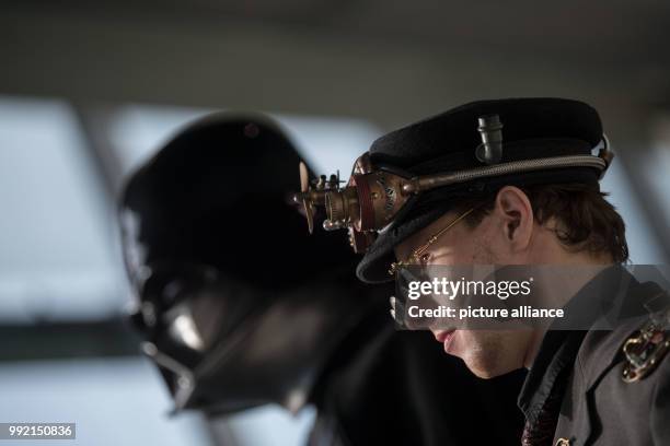 Steampunk performer standing in front of a Darth Vader performer during a photo shoot in Stuttgart, Germany, 23 November 2017. Several fairs are...