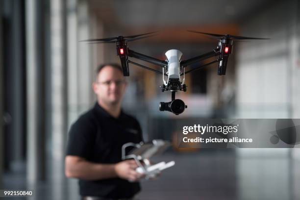 Markus Schaffer flying a DJI Inspire X5 drone in an aisle of the Stuttgart convention center during a photo shoot in Stuttgart, Germany, 23 November...