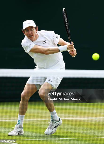 John-Patrick Smith Australia returns a shot against Ben McLachlan of Japan and Jan-Lennard Struff of Germany during their Men's Doubles first round...