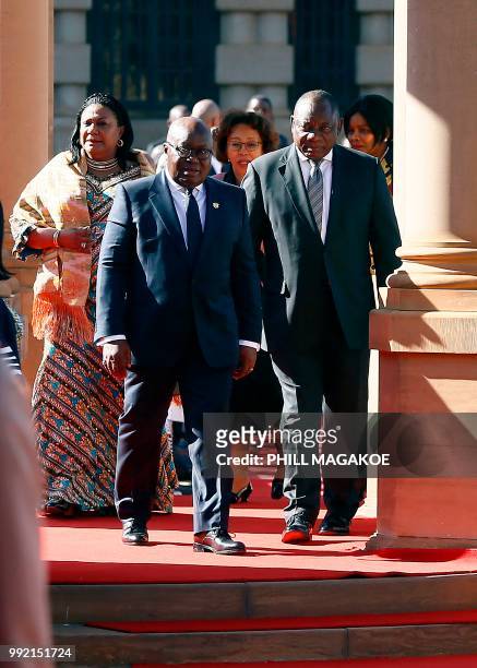 Ghana President Nana Akufo-Addo walks next to South African President Cyril Ramaphosa during a welcoming ceremony at the Union Building in Pretoria,...
