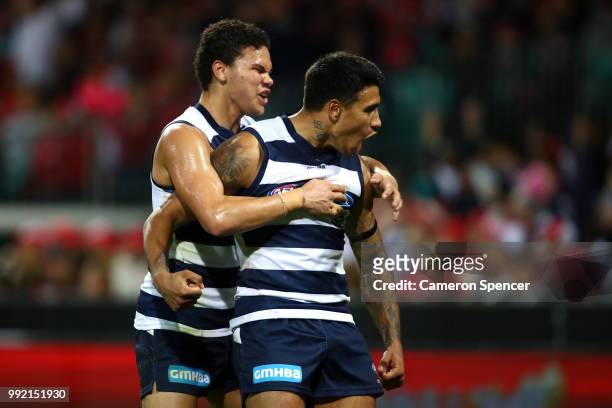 Tim Kelly of the Cats is congratulated by team mate Brandan Parfitt of the Cats during the round 16 AFL match between the Sydney Swans and the...