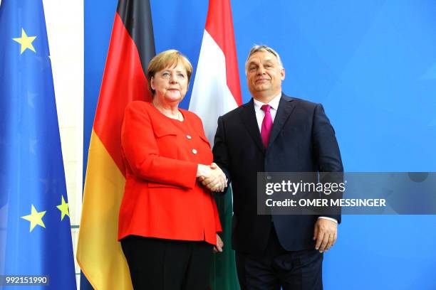 German Chancellor Angela Merkel shakes hands with Hungarian Prime Minister Viktor Orban during a joint press conference following a meeting on July...