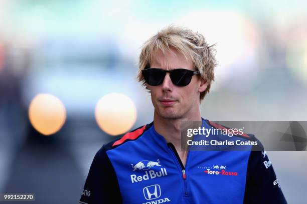 Brendon Hartley of New Zealand and Scuderia Toro Rosso arrives at the circuit during previews ahead of the Formula One Grand Prix of Great Britain at...