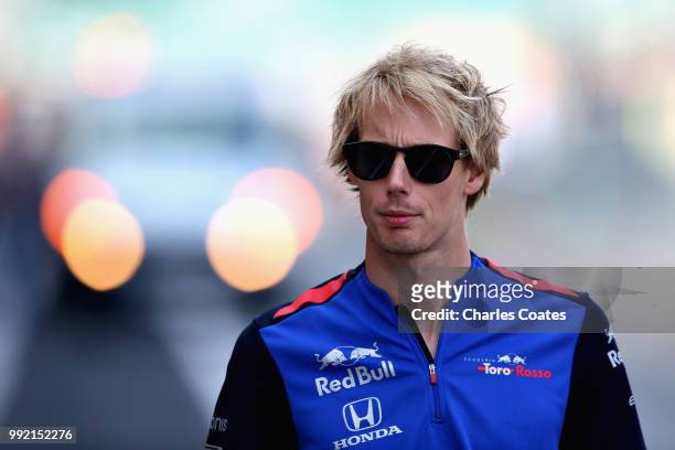 Brendon Hartley of New Zealand and Scuderia Toro Rosso arrives at the circuit during previews ahead of the Formula One Grand Prix of Great Britain at...