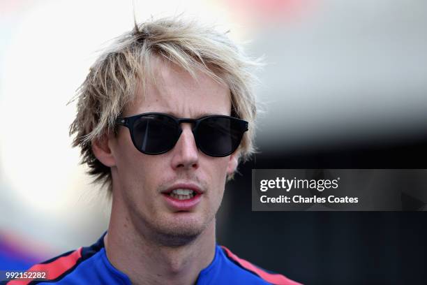 Brendon Hartley of New Zealand and Scuderia Toro Rosso arrives at the circuit during previews ahead of the Formula One Grand Prix of Great Britain at...