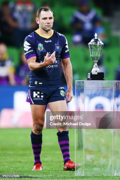 Cameron Smith of the Storm collects the trophy during the round 17 NRL match between the Melbourne Storm and the St George Illawarra Dragons at AAMI...