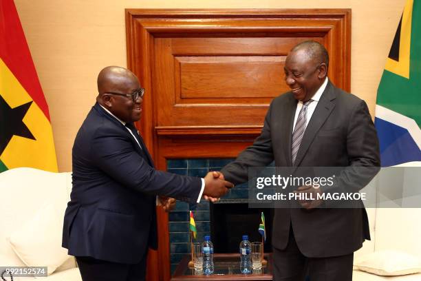 South African President Cyril Ramaphosa shakes hands with Ghana President Nana Akufo-Addo during their meeting at the Union Building in Pretoria, on...