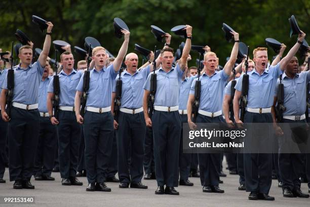 Personnel raise their caps as they practice their drill manouveres during a final marching preparation, at RAF Halton on July 5, 2018 in Halton,...