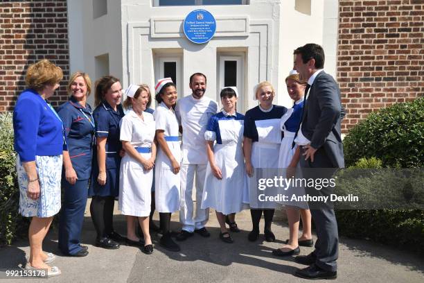 Mayor of Manchester Andy Burnham meets nurses in uniforms to represent each decade of the NHS during a visit to Trafford Hospital to celebrate the...