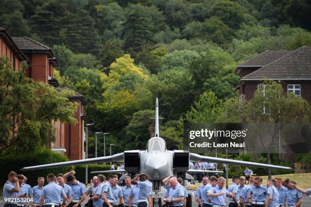 Decommisioned aircraft is seen as RAF personnel relax after practicing their drill manouveres during a final marching preparation, at RAF Halton on...