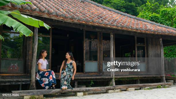 a woman relaxing in an old private house in okinawa - okinawa prefecture stock pictures, royalty-free photos & images