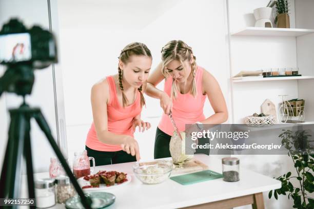 females making a vlog about healthy eating and cutting cabbage - arm made of vegetables stock pictures, royalty-free photos & images
