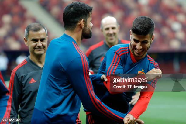 Diego Costa of Spain and Marco Asensio of Spain laugh during a training session on June 30, 2018 in Moscow, Russia.