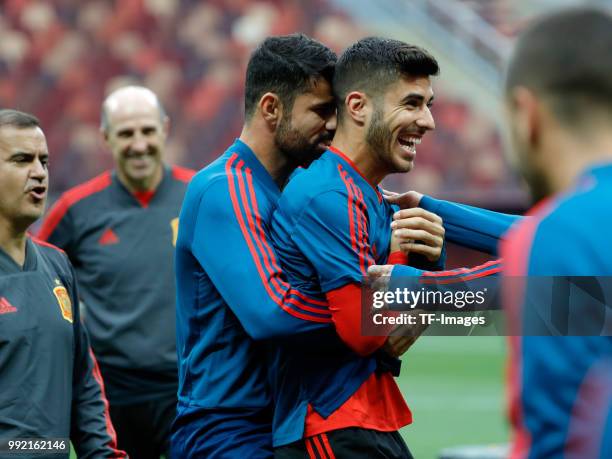 Diego Costa of Spain and Marco Asensio of Spain laugh during a training session on June 30, 2018 in Moscow, Russia.