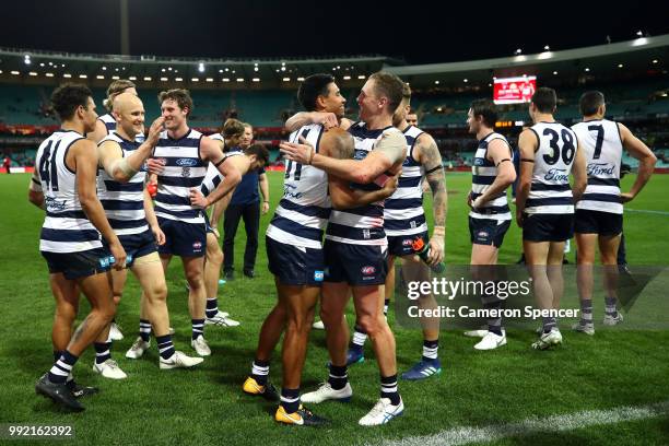 Joel Selwood of the Cats embraces team mate Tim Kelly of the Cats after winning the round 16 AFL match between the Sydney Swans and the Geelong Cats...