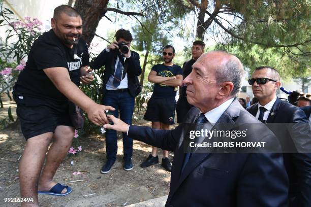 French Minister of Interior Gerard Collomb greets residents of 'Castellane' a cluster of council estate flats built in the 1960s mainly to house the...