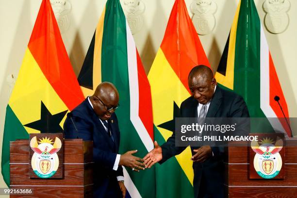 Ghana President Nana Akufo-Addo and South African President Cyril Ramaphosa approach to shake hands after addressing a joint press conference...