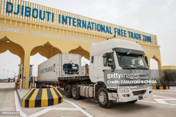 Container truck passes through the main gate of Djibouti International Free Trade Zone after the inauguration ceremony in Djibouti on July 5, 2018.