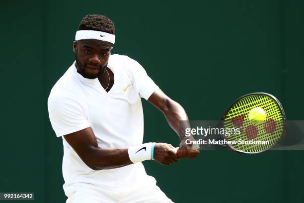 Frances Tiafoe of the United States returns a shot against Julien Benneteau of France during their Men's Singles second round match on day four of...