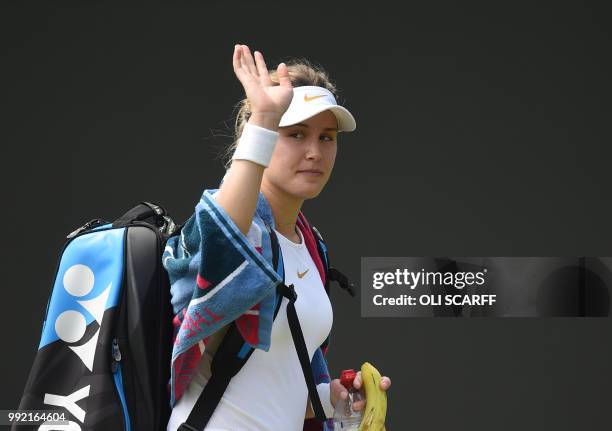 Canada's Eugenie Bouchard waves after losing to Australia's Ashleigh Barty 6-4, 7-5 in their women's singles second round match on the fourth day of...