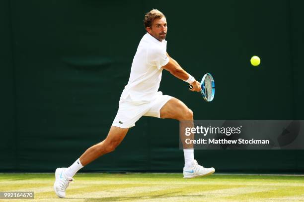 Julien Benneteau of France returns a shot against Frances Tiafoe of the United States during their Men's Singles second round match on day four of...