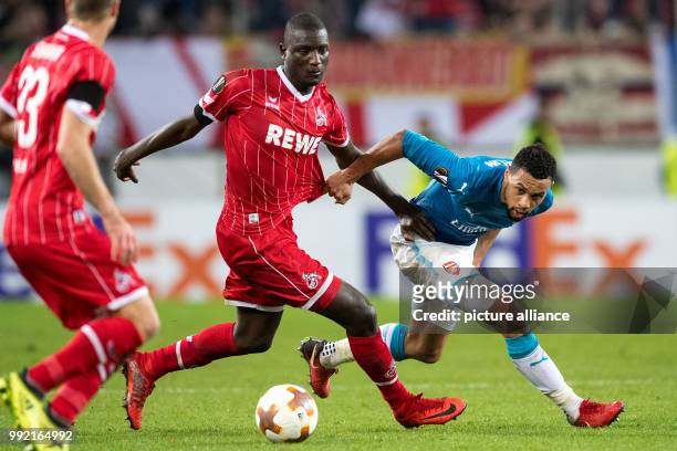 Cologne's Sehrou Guirassy and Arsenal's Francis Coquelin vie for the ball during the Europa League group match between 1. FC Cologne and FC Arsenal,...