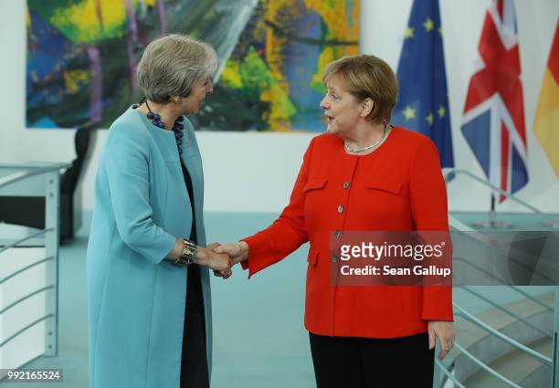 German Chancellor Angela Merkel and British Prime Minister Theresa May give statements to the media prior to talks at the Chancellery on July 5, 2018...
