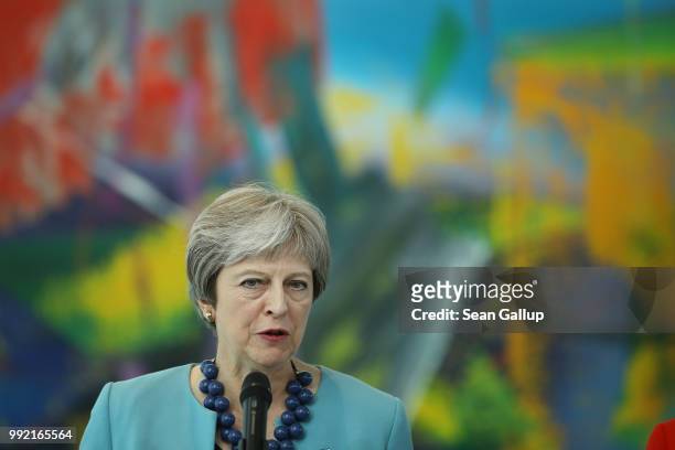 British Prime Minister Theresa May and German Chancellor Angela Merkel give statements to the media prior to talks at the Chancellery on July 5, 2018...