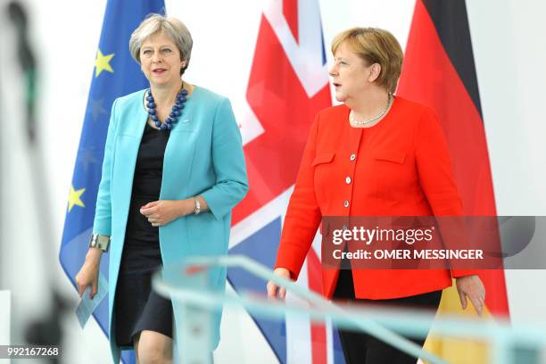 German Chancellor Angela Merkel and British Prime Minister Theresa May arrive to talk to the press as part of a meeting on July 5, 2018 in Berlin as...