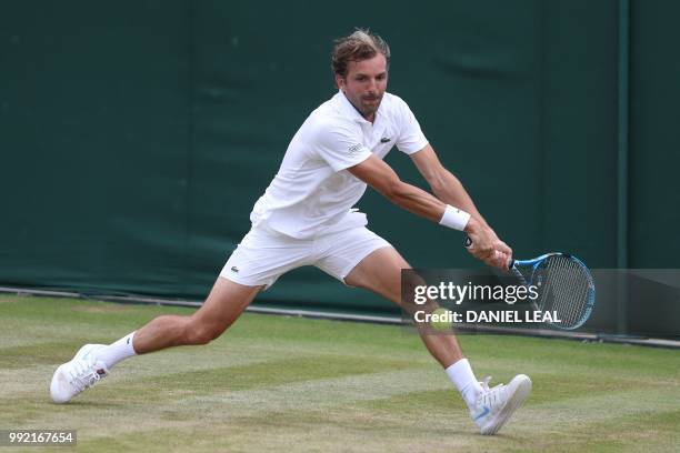 France's Julien Benneteau returns to US player Frances Tiafoe during their men's singles second round match on the fourth day of the 2018 Wimbledon...