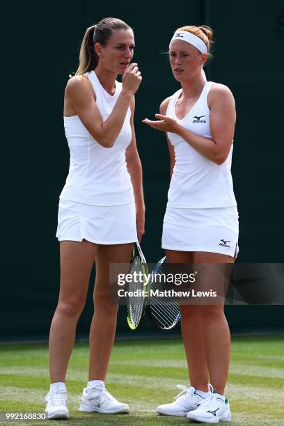 Xenia Knoll of Switzerland and Anna Smith of Great Britain talk against Raquel Atawo of the United States and Anna-Lena Groenefeld of Germany during...