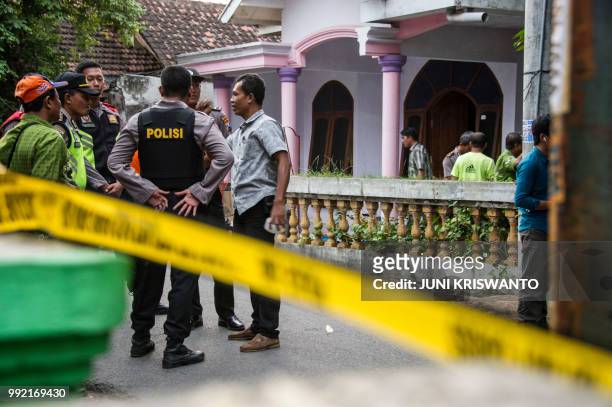 Indonesian police conduct an investigation at a house in the city of Bangil, East Java province on July 5 after an alleged terrorist who managed to...