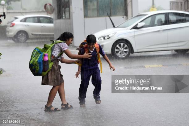 Children enjoy during the rain at Road Pali, on July 4, 2018 in Mumbai, India. Heavy rains made a comeback in Mumbai causing waterlogging in many...