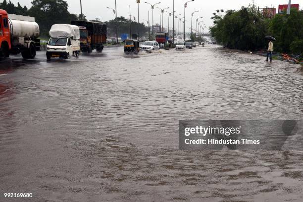Vehicles wade through on water logging road at Kalmboli, on July 4, 2018 in Mumbai, India. Heavy rains made a comeback in Mumbai causing waterlogging...