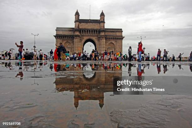 People take selfie and chill while it rains at Gateway of India, on July 4, 2018 in Mumbai, India. Heavy rains made a comeback in Mumbai causing...
