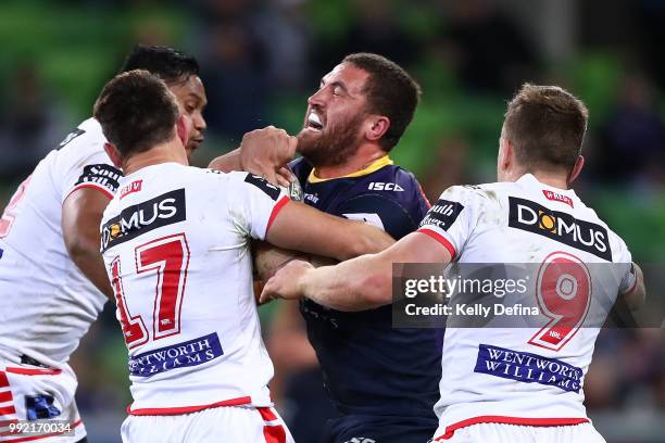 Kenneath Bromwich of the Storm is tackled by Dragons defense during the round 17 NRL match between the Melbourne Storm and the St George Illawarra...