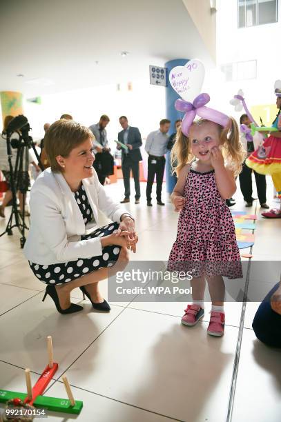 Scotland's First Minister Nicola Sturgeon poses for a photograph with 2-year-old Dervla Docherty during a visit to the Royal Hospital for Children to...